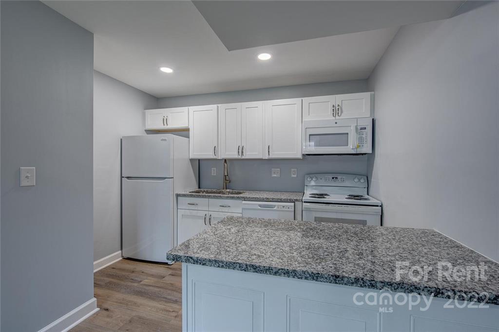 1048 Avondale Road, Unit 14 Lowell, NC 28098 - Photo 6 of 11 a kitchen with stainless steel appliances granite countertop a refrigerator sink and cabinets