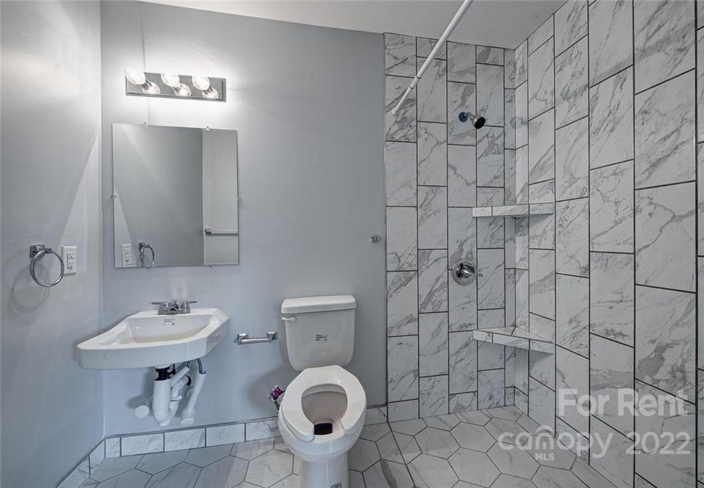 1048 Avondale Road, Unit 14 Lowell, NC 28098 - Photo 10 of 11 a bathroom with a sink toilet and shower