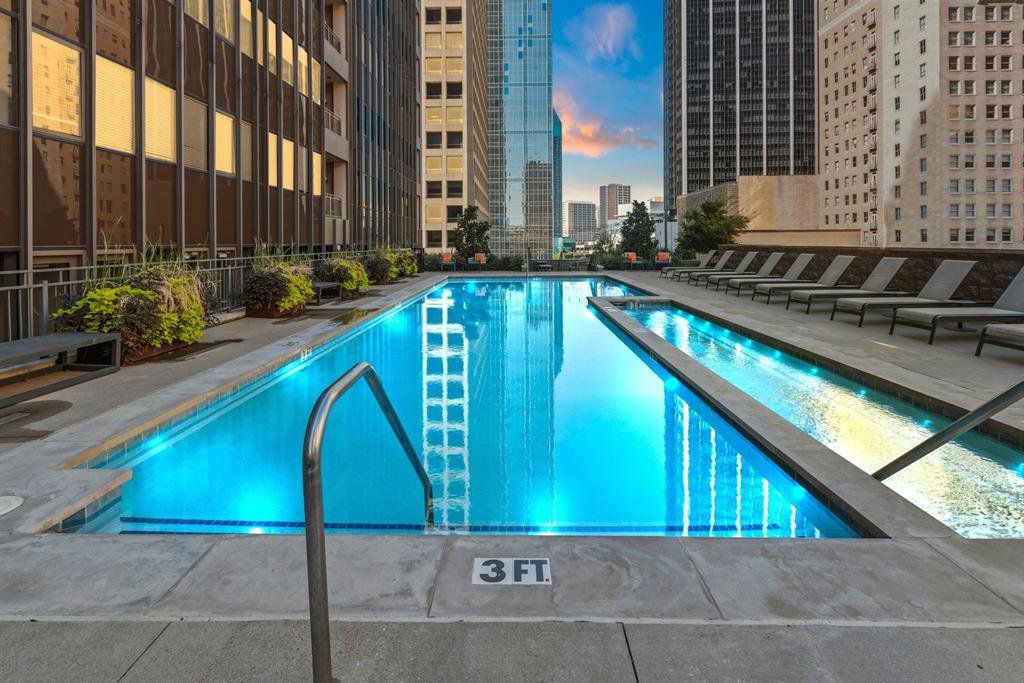 1200 Main Street, Unit 408 Dallas, TX 75202 - Photo 1 of 5 a view of swimming pool with lawn chairs and potted plants