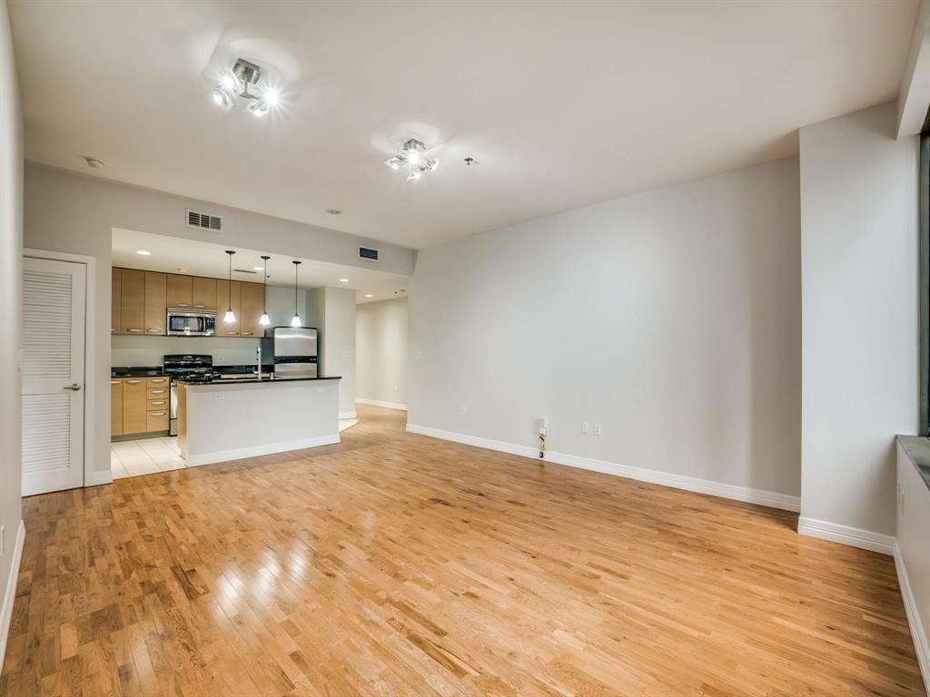 a view of kitchen with refrigerator sink and wooden floor