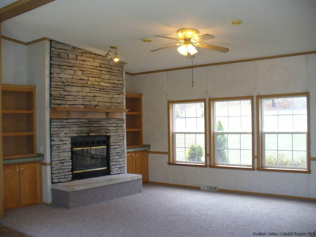 121 Rochester Center Road Accord, NY 12404 - Photo 3 of 23 a view of an empty room with a fireplace and a window