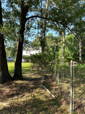 a view of a yard with large trees