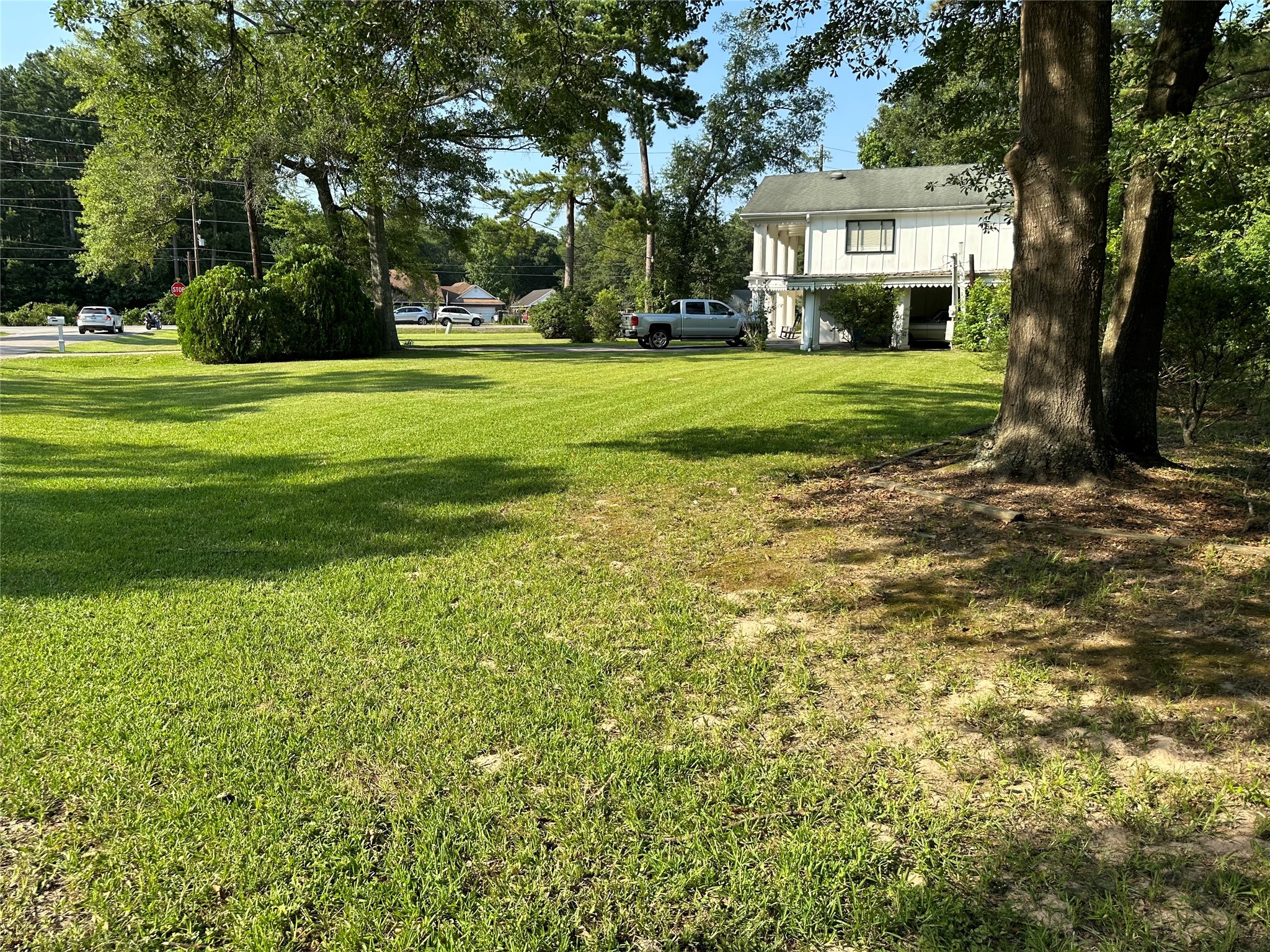 15361 Westgate Road Splendora, TX 77372 - Photo 8 of 18 a view of a big house with a big yard and large trees