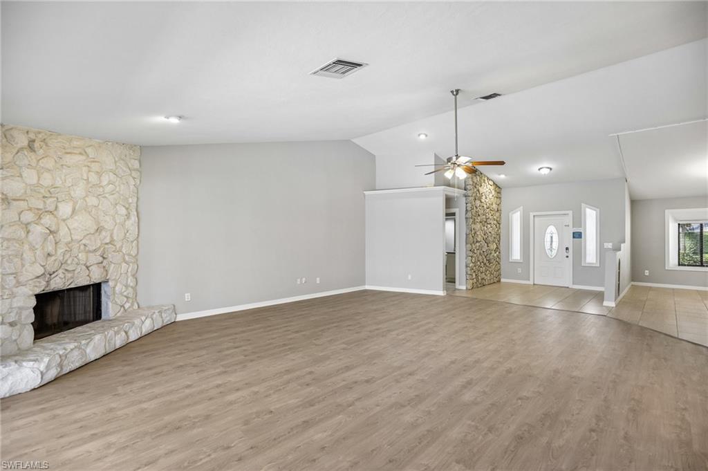 1937 Princess Court Naples, FL 34110 - Photo 11 of 42 an empty room with wooden floor and fireplace