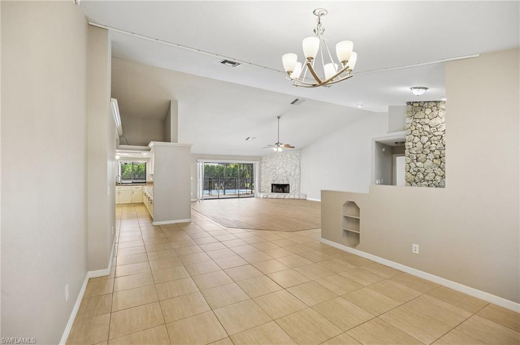 1937 Princess Court Naples, FL 34110 - Photo 15 of 42 a view of a livingroom with a chandelier furniture and a large window