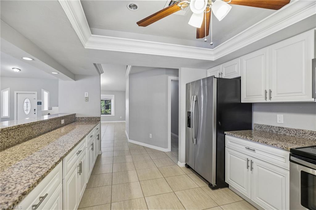 1937 Princess Court Naples, FL 34110 - Photo 19 of 42 a large kitchen with stainless steel appliances granite countertop a sink and refrigerator