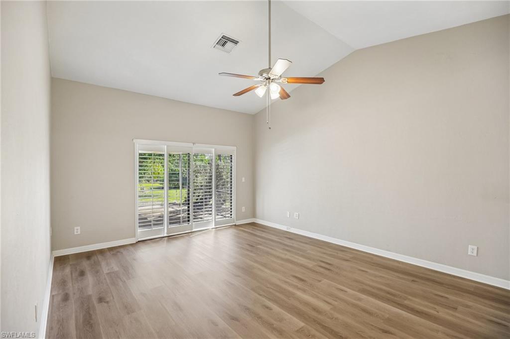 1937 Princess Court Naples, FL 34110 - Photo 20 of 42 an empty room with wooden floor fan and windows