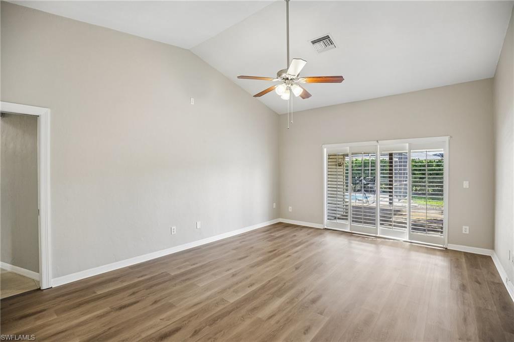 1937 Princess Court Naples, FL 34110 - Photo 21 of 42 an empty room with wooden floor fan and windows