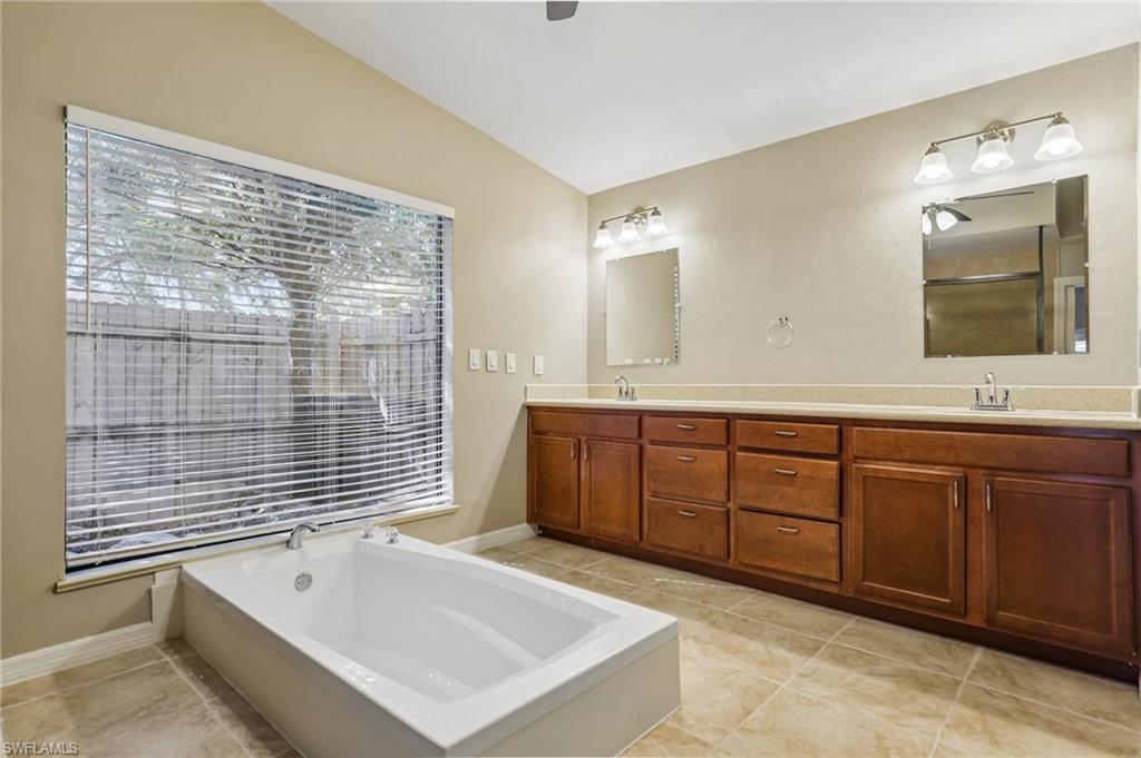 1937 Princess Court Naples, FL 34110 - Photo 24 of 42 a bathroom with a tub sink and mirror