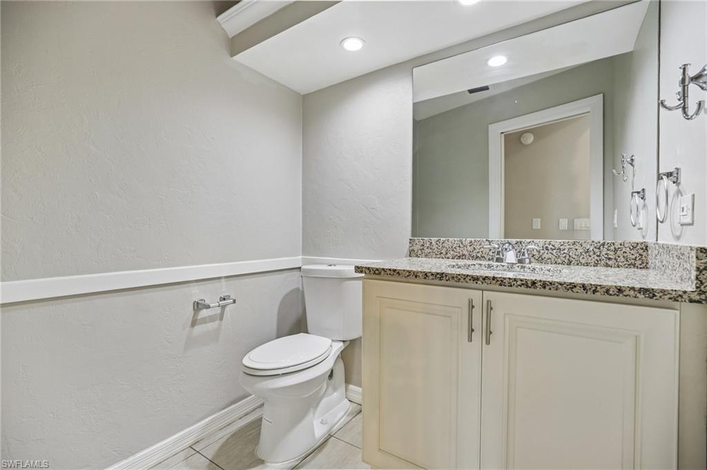 1937 Princess Court Naples, FL 34110 - Photo 25 of 42 a bathroom with a granite countertop sink mirror vanity and toilet
