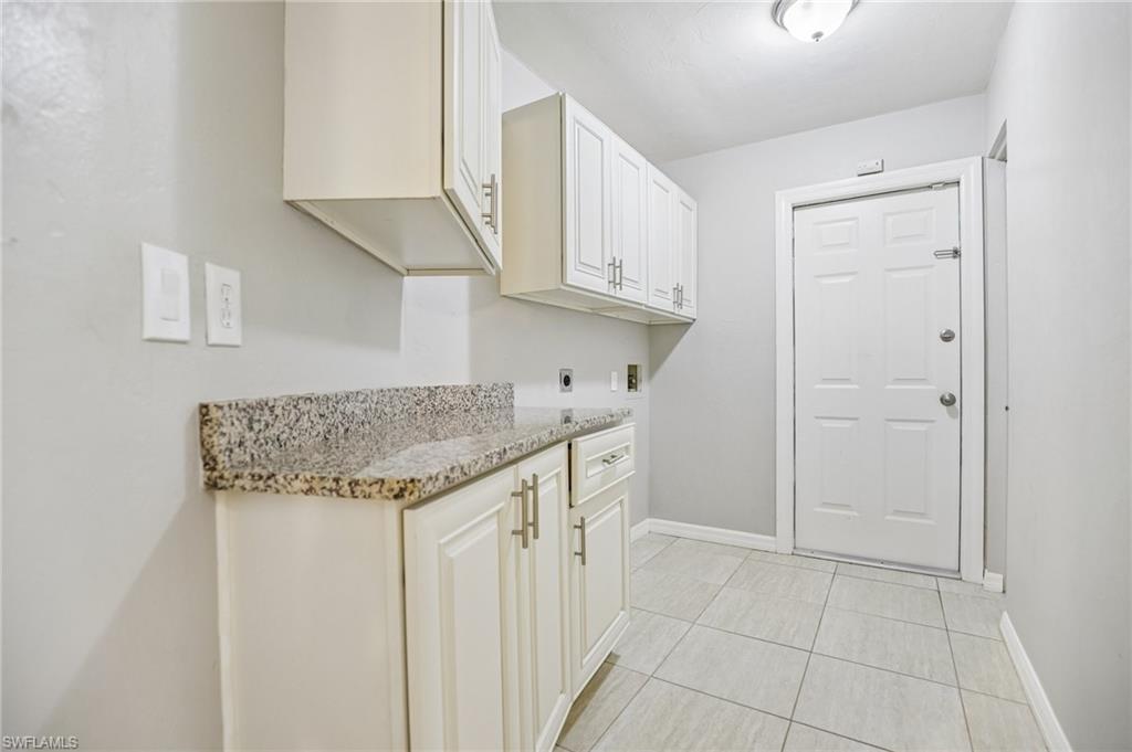 1937 Princess Court Naples, FL 34110 - Photo 26 of 42 a kitchen with stainless steel appliances granite countertop a sink and cabinets