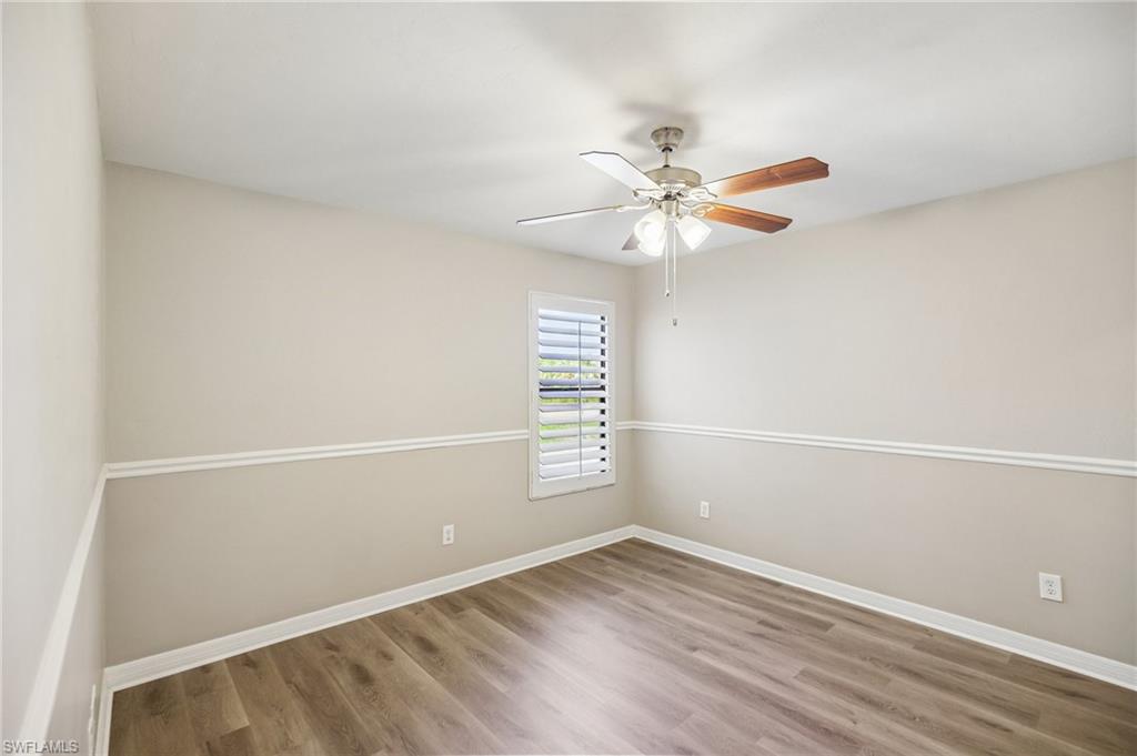 1937 Princess Court Naples, FL 34110 - Photo 28 of 42 an empty room with a window and a ceiling fan