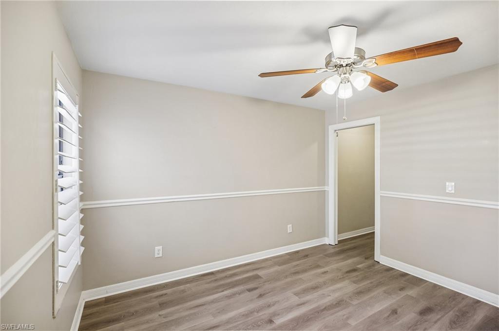 1937 Princess Court Naples, FL 34110 - Photo 29 of 42 an empty room with wooden floor closet and fan