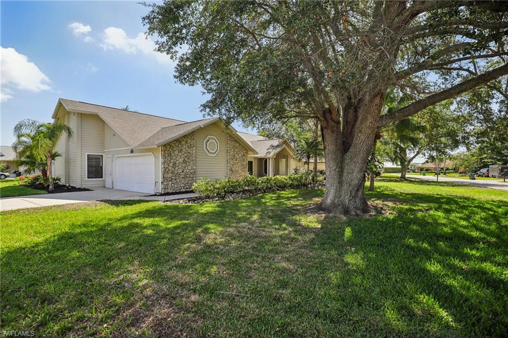 1937 Princess Court Naples, FL 34110 - Photo 3 of 42 a front view of house with yard and green space