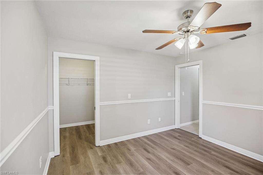 1937 Princess Court Naples, FL 34110 - Photo 31 of 42 an empty room with wooden floor closet and fan