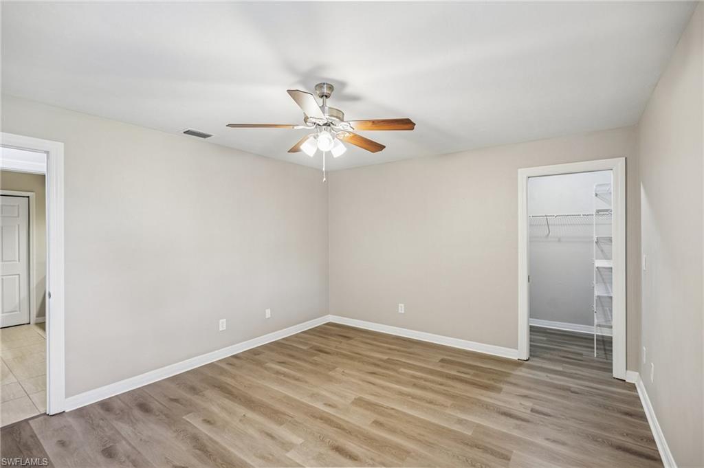 1937 Princess Court Naples, FL 34110 - Photo 33 of 42 a view of a room with wooden floor and a ceiling fan