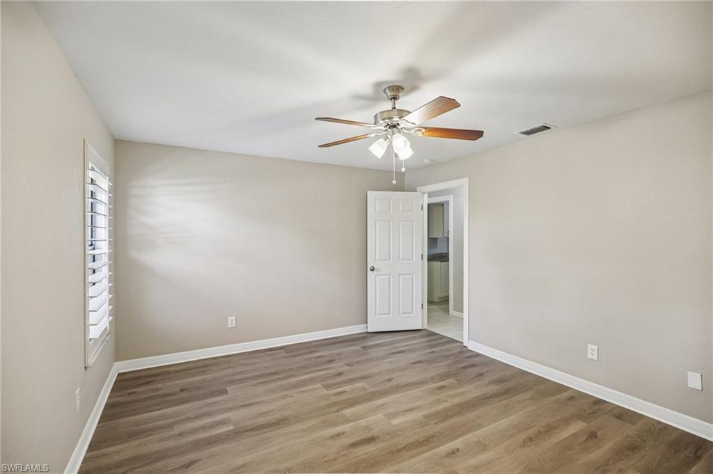 1937 Princess Court Naples, FL 34110 - Photo 34 of 42 an empty room with wooden floor and ceiling fan