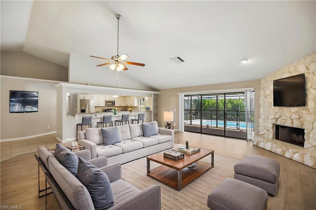 1937 Princess Court Naples, FL 34110 - Photo 4 of 42 a living room with furniture fireplace and flat screen tv