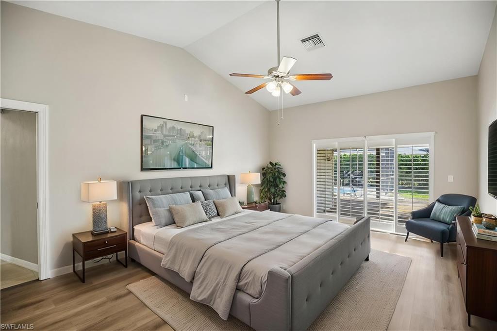 1937 Princess Court Naples, FL 34110 - Photo 5 of 42 a spacious bedroom with a large bed and a couch