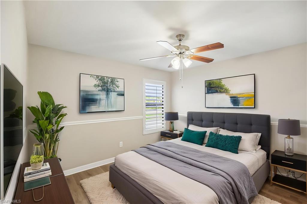 1937 Princess Court Naples, FL 34110 - Photo 6 of 42 a bedroom with a bed and a potted plant