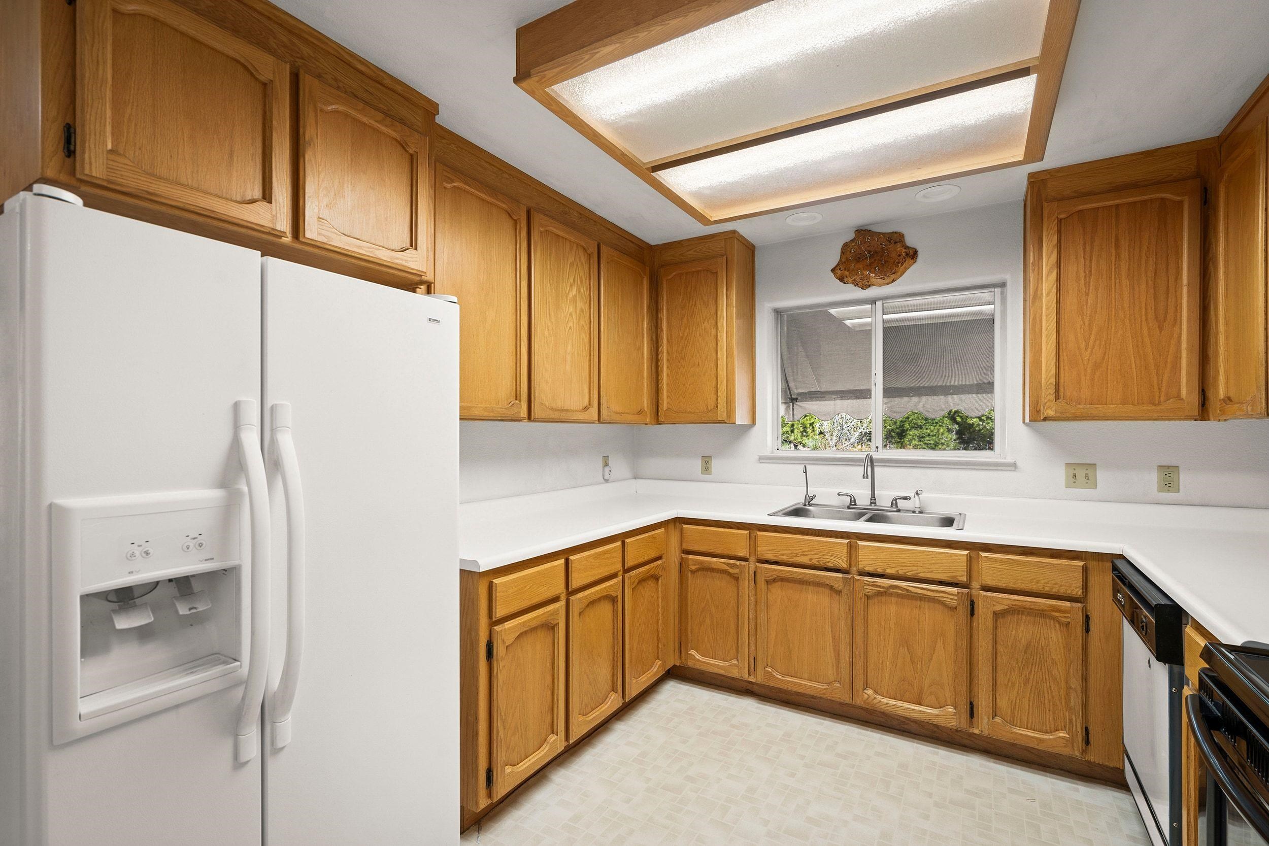 1020 Sunrise Creek Road Loyalton, CA 96118 - Photo 11 of 27 a kitchen with a sink a refrigerator and cabinets
