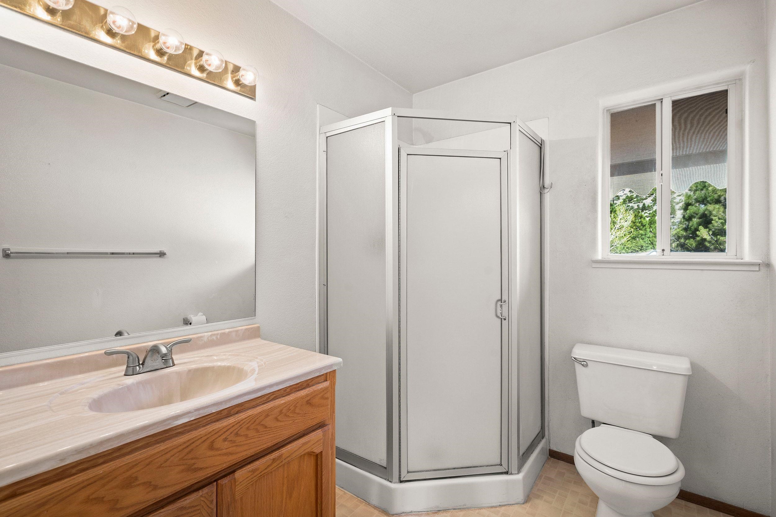 1020 Sunrise Creek Road Loyalton, CA 96118 - Photo 24 of 27 a bathroom with a granite countertop sink toilet and shower