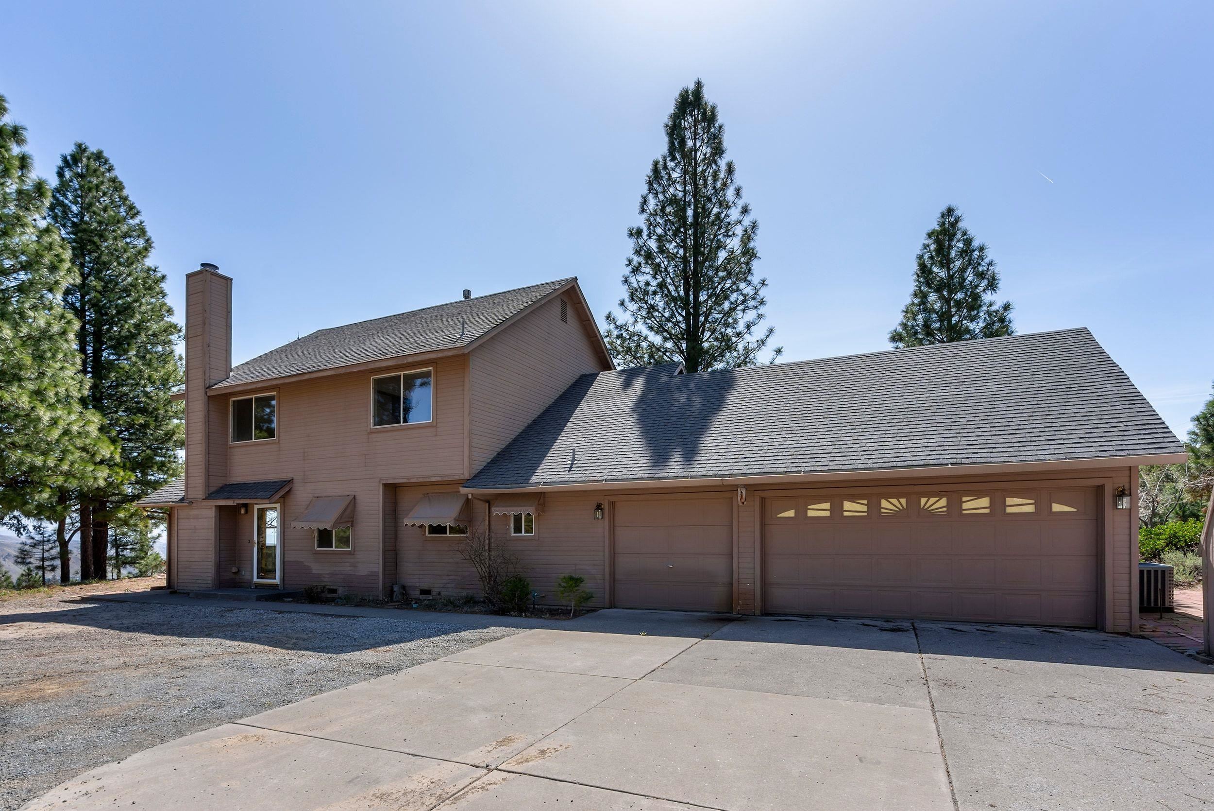 1020 Sunrise Creek Road Loyalton, CA 96118 - Photo 25 of 27 a front view of a house with a yard and garage