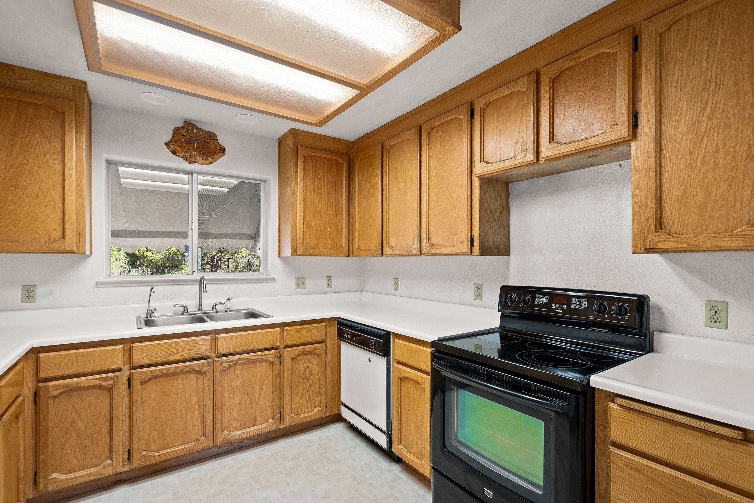 1020 Sunrise Creek Road Loyalton, CA 96118 - Photo 10 of 27 a kitchen with stainless steel appliances granite countertop a sink stove and cabinets