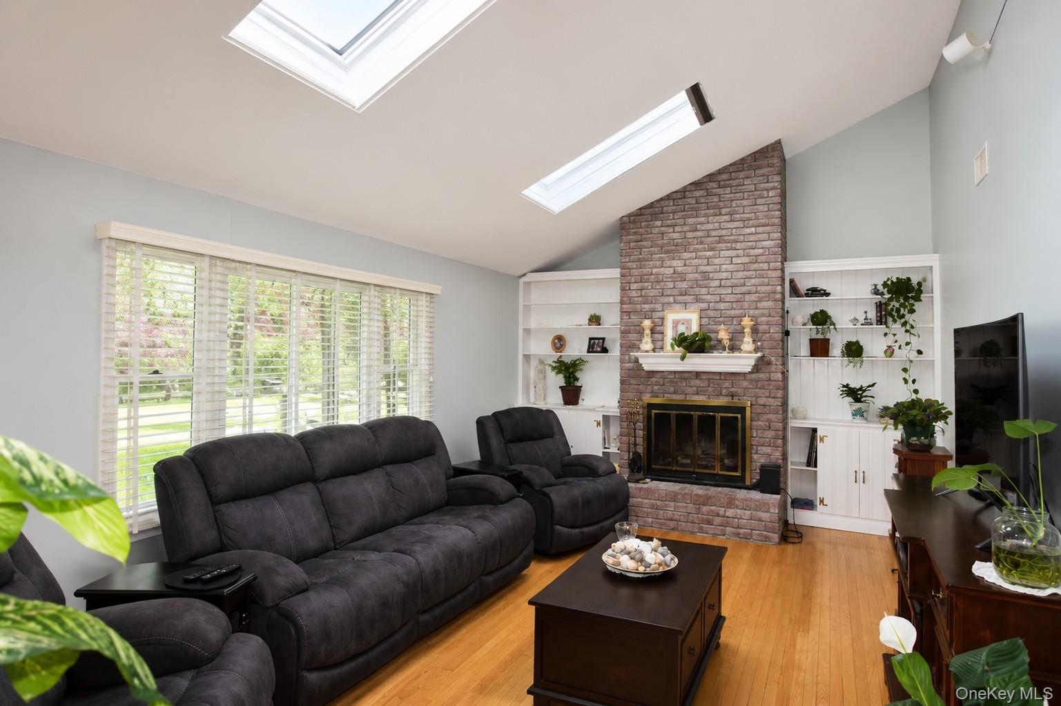 5 Stillwood Road Brookhaven, NY 11719 - Photo 7 of 22 Living room with 2 skylights and wood burning fireplace.