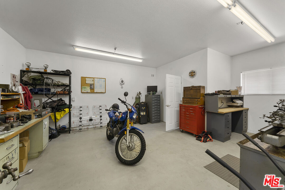 8391 Hillside Road Rancho Cucamonga, CA 91701 - Photo 22 of 51 a view of a garage with a table and chairs