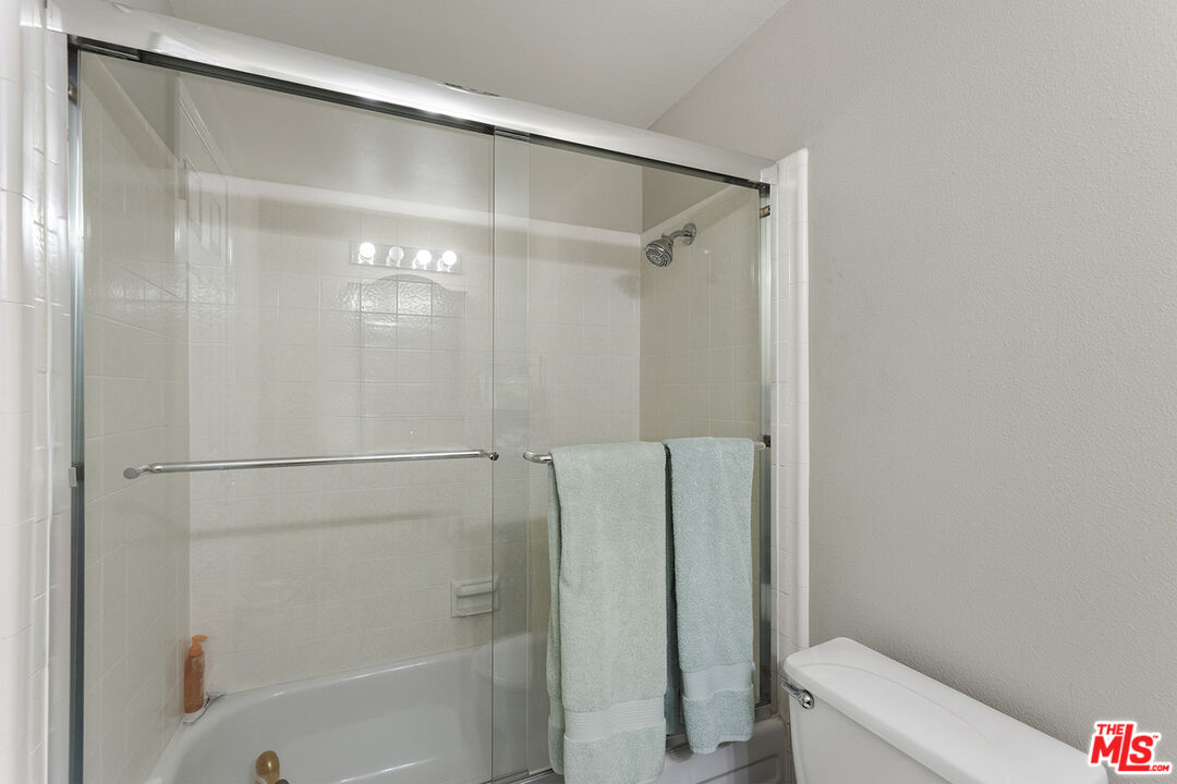 8391 Hillside Road Rancho Cucamonga, CA 91701 - Photo 29 of 51 a bathroom with a sink a toilet and mirror