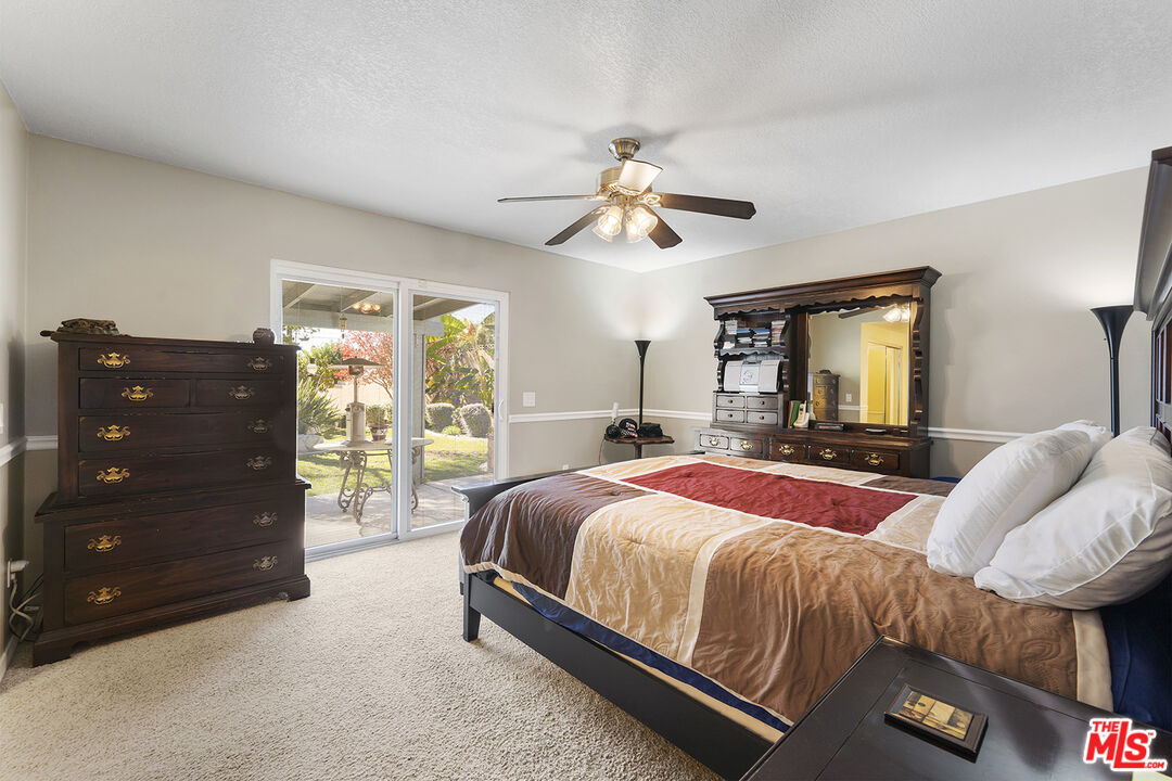 8391 Hillside Road Rancho Cucamonga, CA 91701 - Photo 32 of 51 a bedroom with a bed and wooden floor