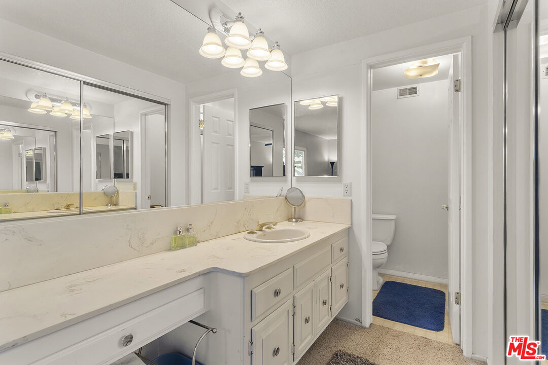 8391 Hillside Road Rancho Cucamonga, CA 91701 - Photo 35 of 51 a spacious bathroom with a granite countertop sink a mirror and shower
