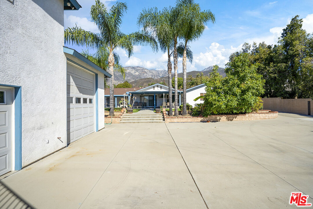 8391 Hillside Road Rancho Cucamonga, CA 91701 - Photo 10 of 51 a living room with furniture a flat screen tv and kitchen view