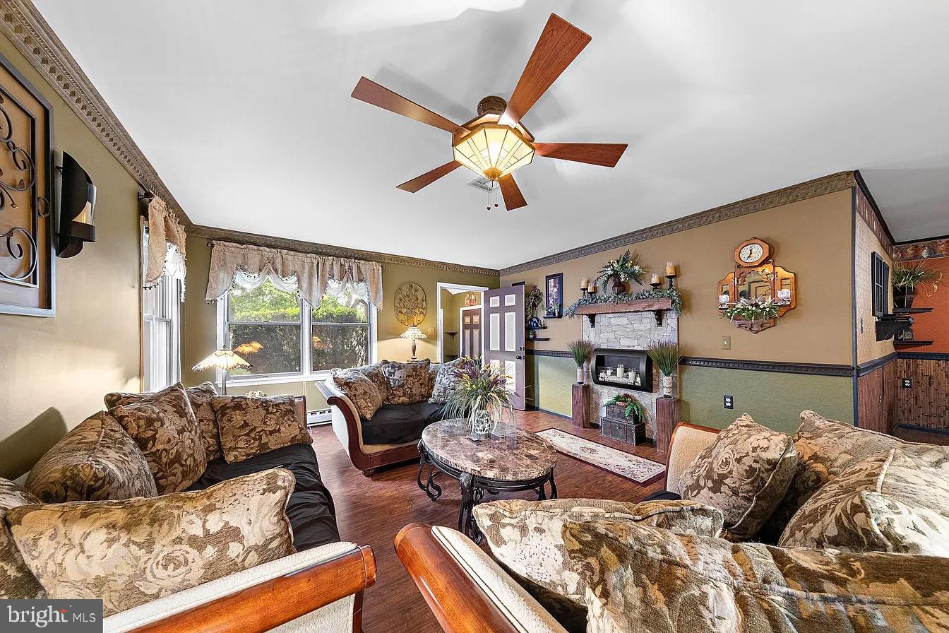 22 Fir Road Manahawkin, NJ 08050 - Photo 8 of 35 a living room with furniture ceiling fan and a large window