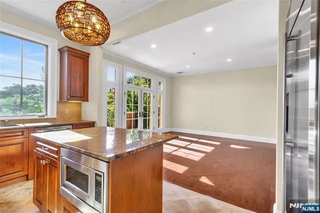 a open kitchen with granite countertop a stove and a sink