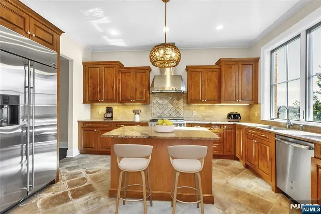 a kitchen with kitchen island granite countertop a sink window and cabinets