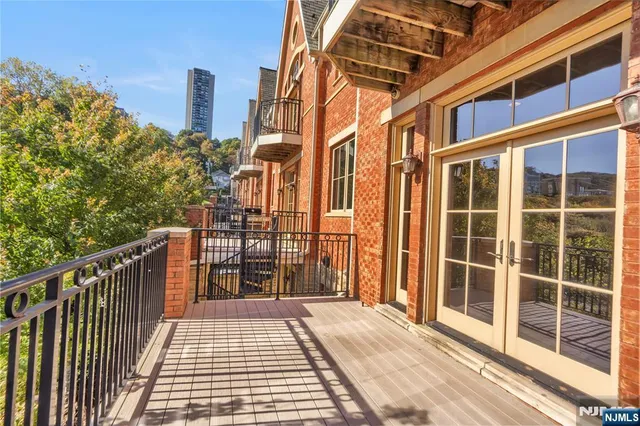 a view of a balcony with wooden floor and city view