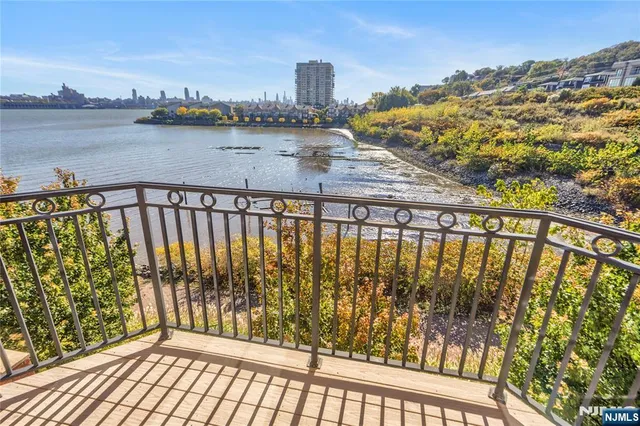 a view of a lake with boats and trees in the background