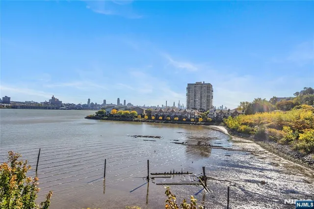 a bathroom with a granite countertop toilet sink and mirror