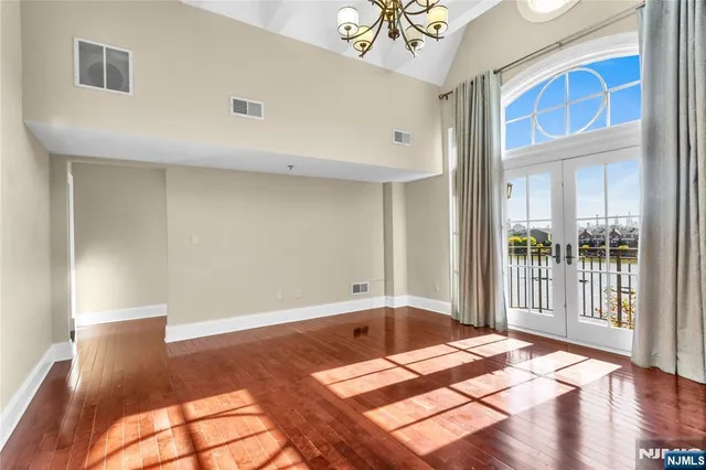 a bathroom with a granite countertop double vanity sink and a mirror