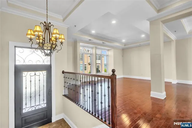 a view of a room with wooden floor and windows