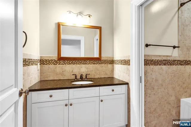a bedroom with a large bed wooden floor and window