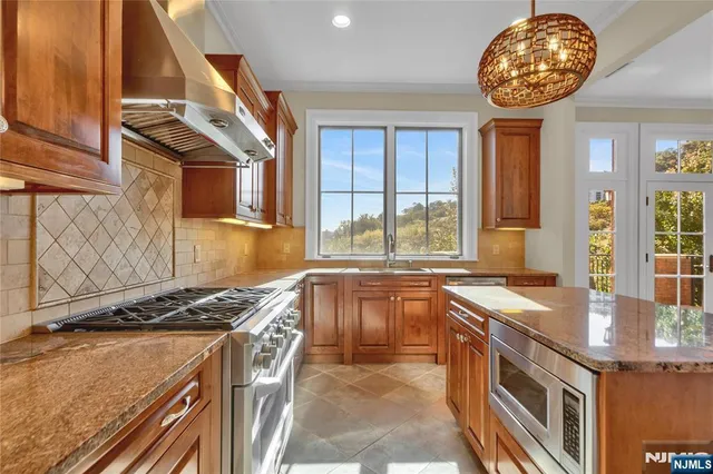 a kitchen with stainless steel appliances granite countertop a stove and a sink