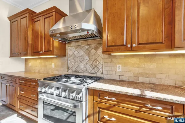 a kitchen with granite countertop a stove and a cabinet