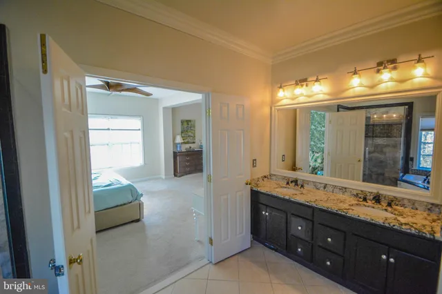 a en suite bathroom with a double vanity sink and a mirror