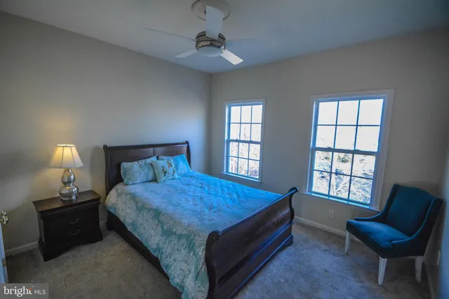 a bed room with a bed and a chair