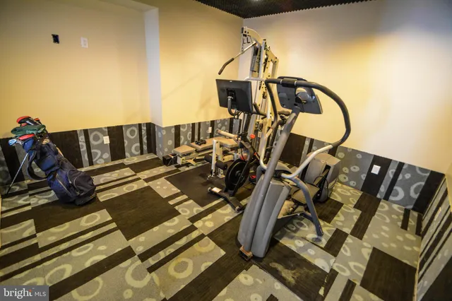 a living room with hard wood flooring and a gym