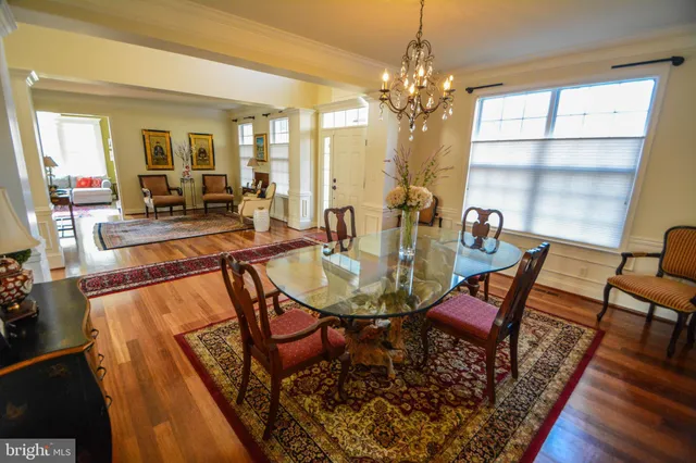 a view of a dining room with furniture and a chandelier