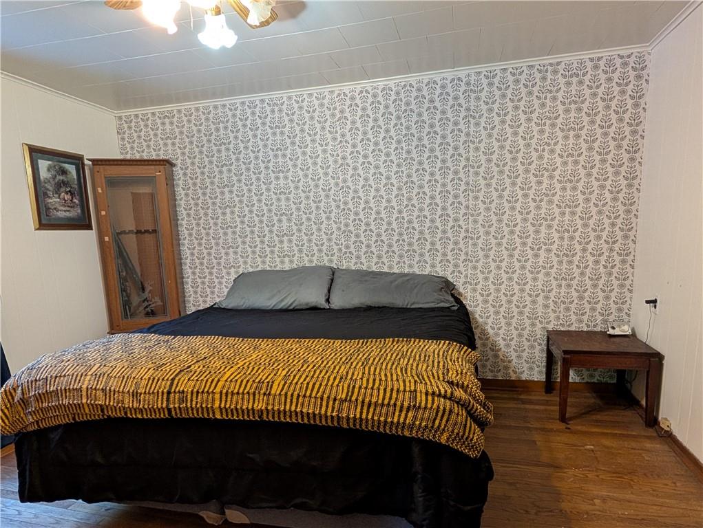 205 Woods Road Ligonier, PA 15658 - Photo 10 of 32 a bedroom with a bed and wooden floor